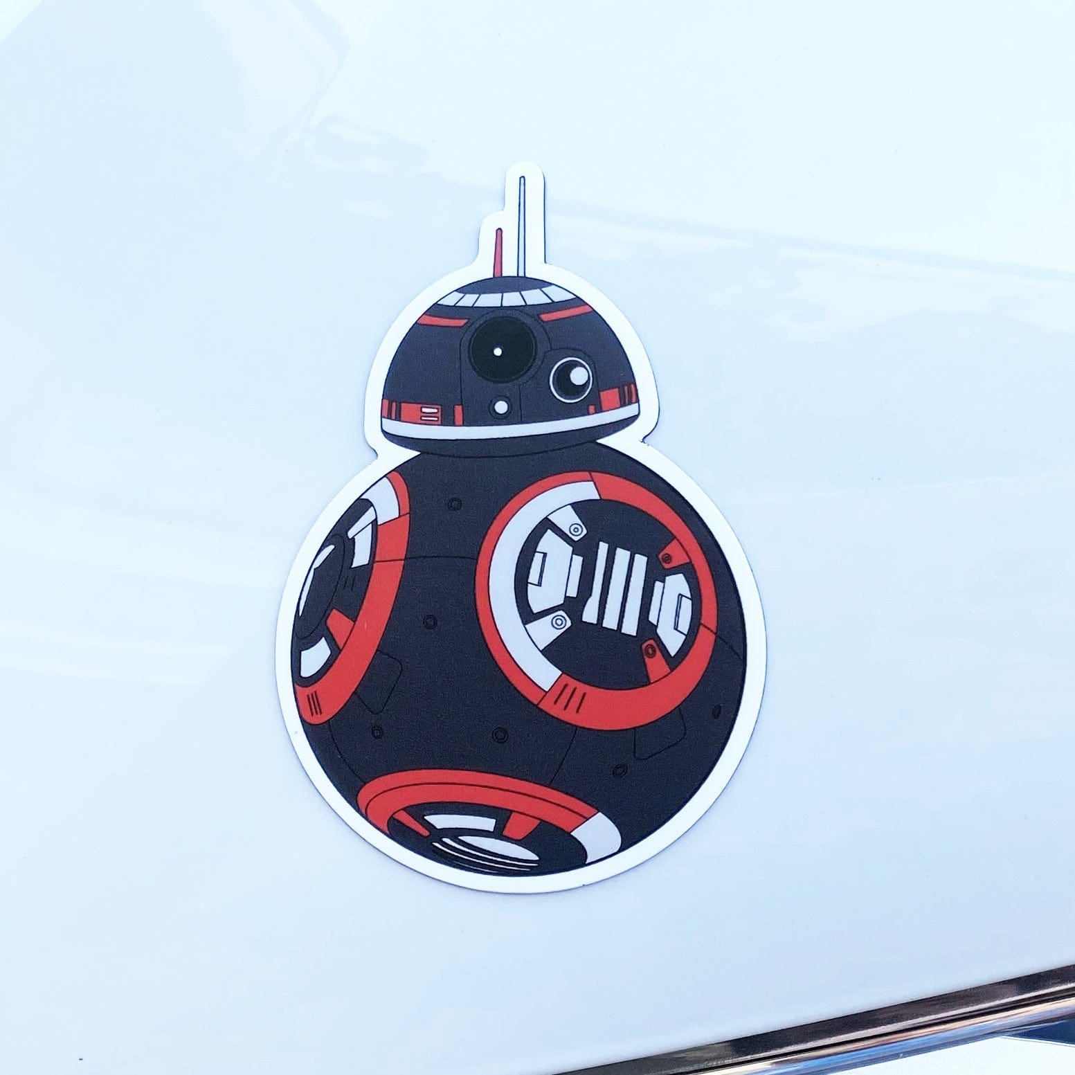Custom BB-9E droid magnet inspired by Star Wars, featuring a black and red design on a white surface. Ideal for fans of sci-fi, tech, and pop culture decals.