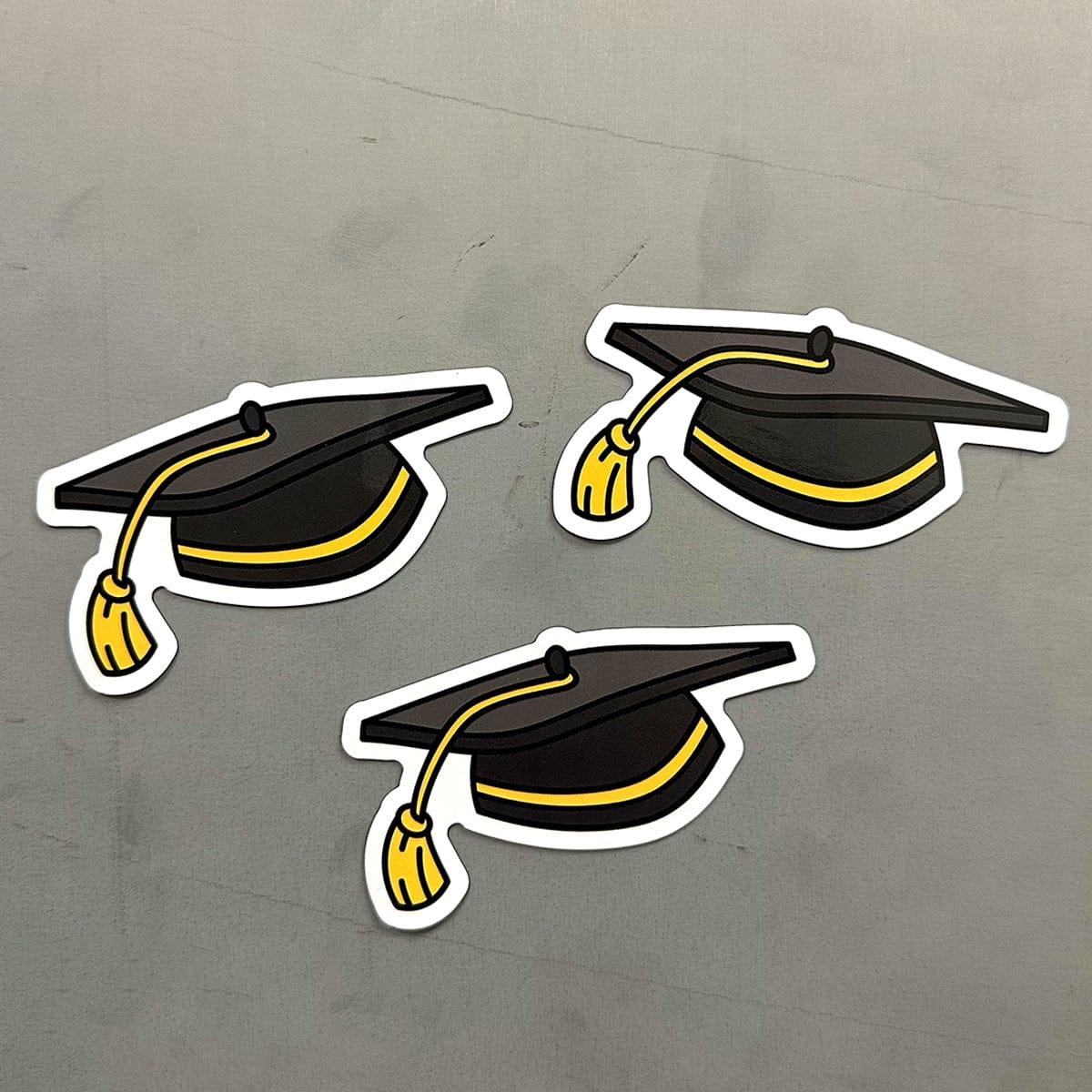 Custom graduation cap magnets with black and gold tassels, perfect for celebrating graduates, decorating lockers or fridges, and gifting during commencement season.