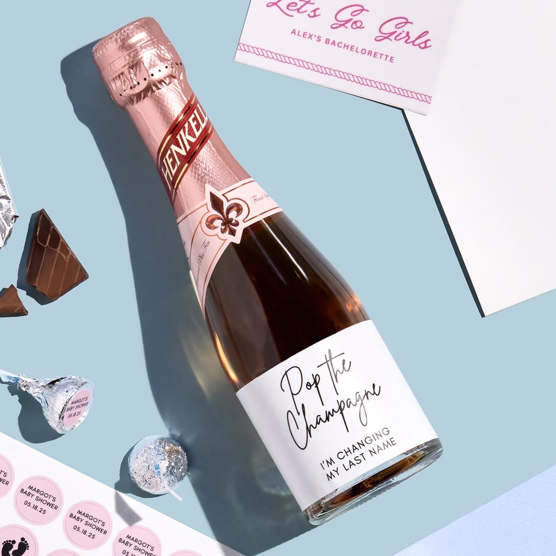 Custom bachelorette champagne bottle label with “Pop the Champagne” design on a pink sparkling wine bottle